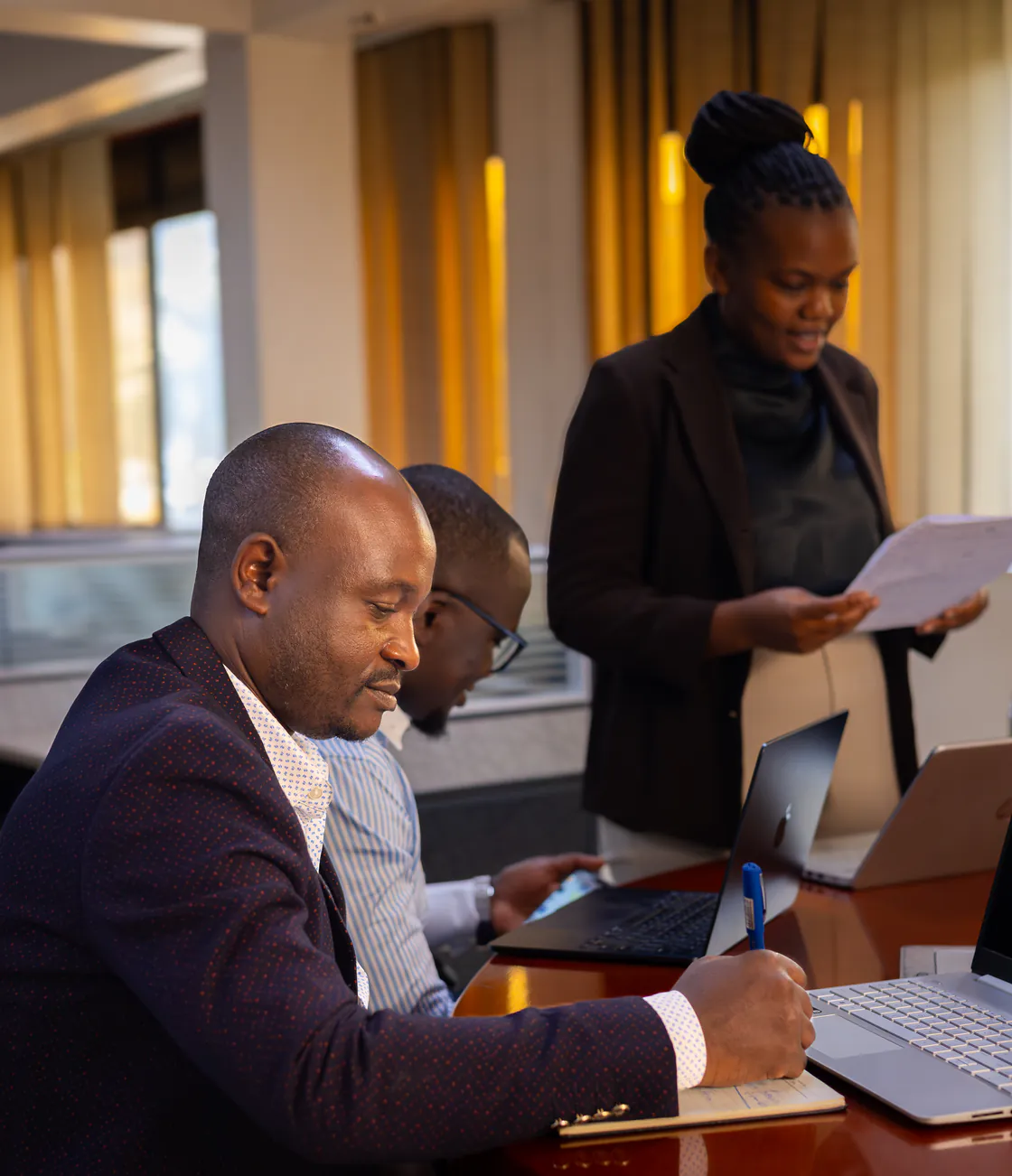 Kisaka team working through a file together at the meeting table