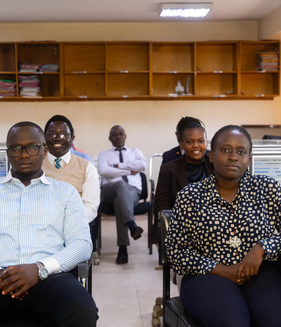 Five members of the Kisaka team seated together in the office